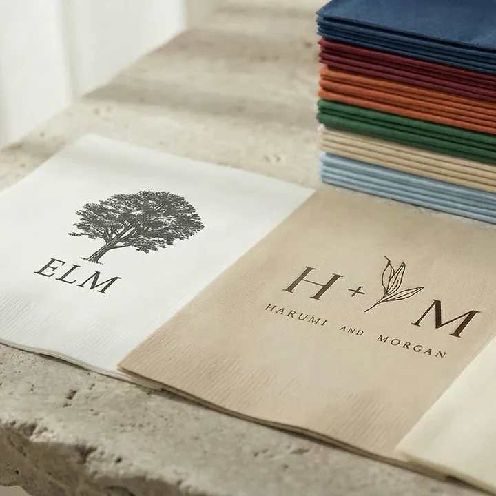 Custom printed Singular napkins showing client logos and artwork in multiple colors